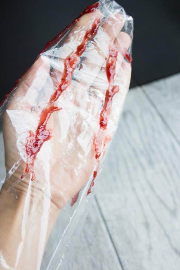 raspberry jam being drizzled into a piping bag before filling with meringue