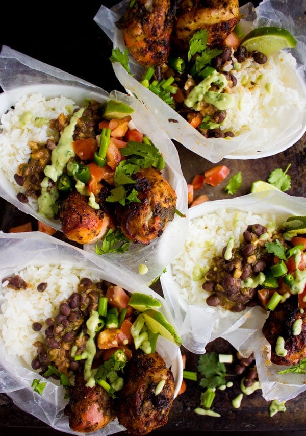 overhead shot of four servings of Cuban Black Beans Chicken and Rice with fresh salsa