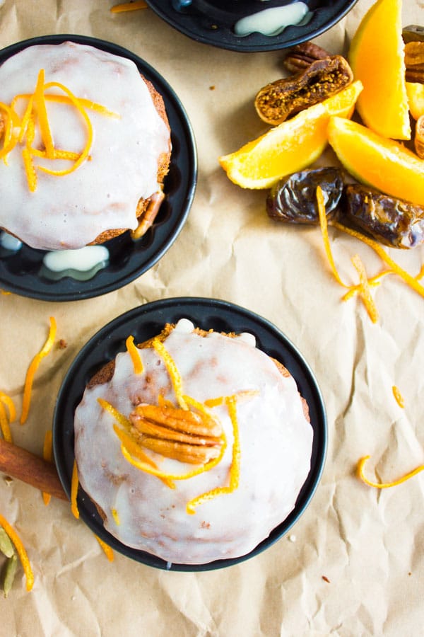 overhead of Orange Chai Spice Date Muffins topped with cream cheese icing and orange zest 