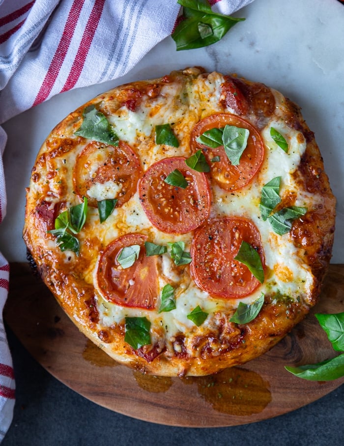 close up of a baked Margherita pizza with melted cheese