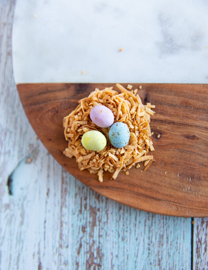 a nest of coconut shreds and chocolate eggs