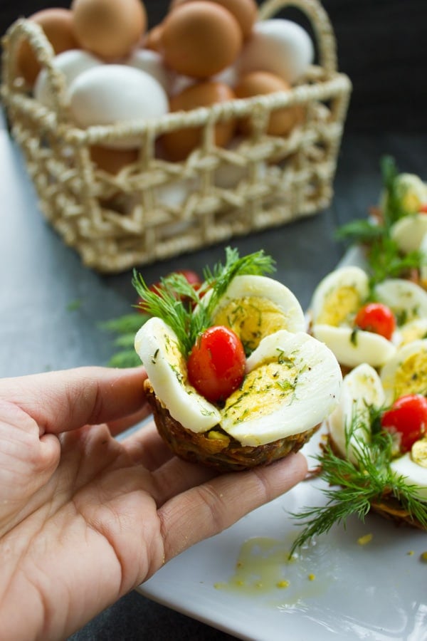 a hand holding a Easter Egg Tart Potato Nest