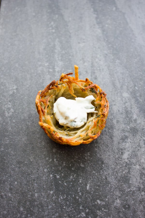 crispy baked potato nest with a dollop of cream cheese inside