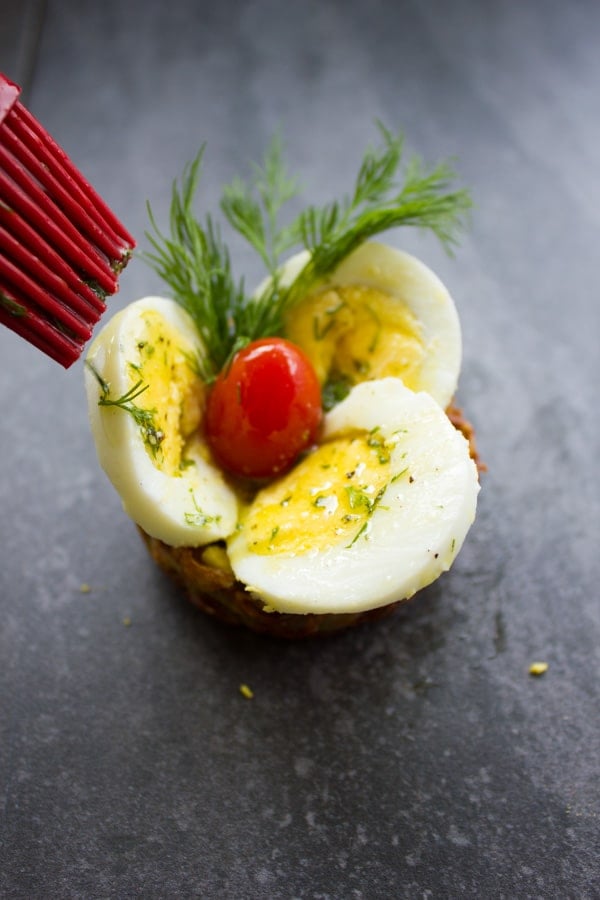 Easter Egg Tart Potato Nests being brushed with dill butter