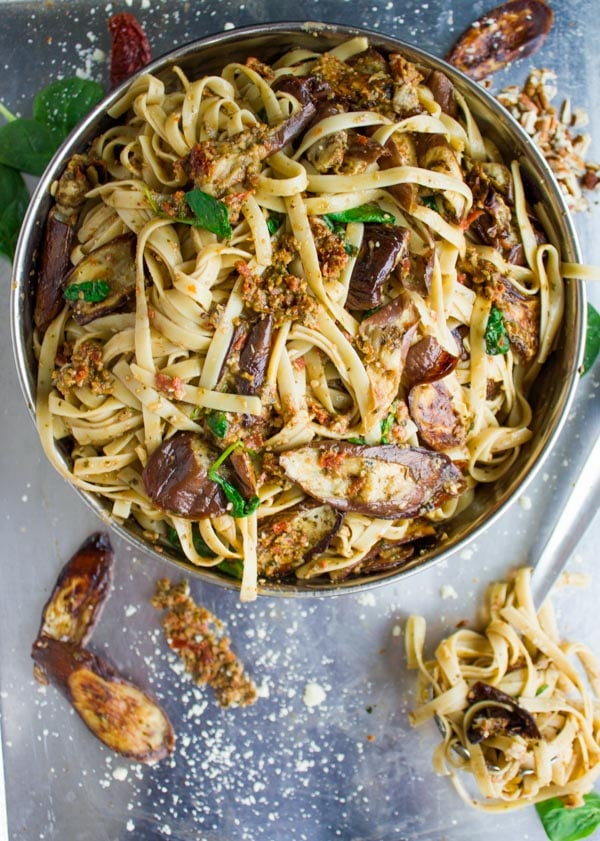 overhead shot of Skinny Eggplant Parmesan Pasta in a bowl surrounded by dun-dried tomatoes