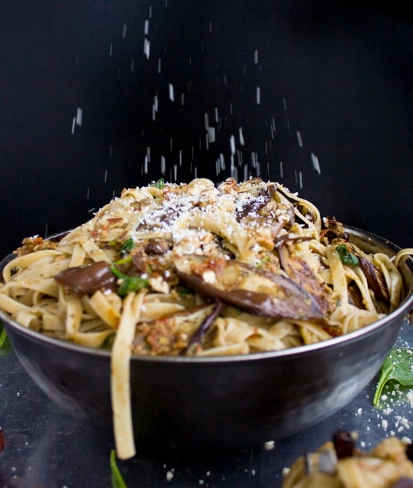 a bowl of Skinny Eggplant Parmesan Pasta being sprinkled with parmesan cheese