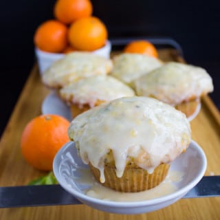 Ginger Clementine Lemon Poppy Seed Muffins. Easy one bowl one whisk muffins that BURST with lemon and poppy seed, spiked with a bit of ginger and clementine glaze. Don;t miss this RECIPE for the fluffiest, lightest, freshest tasting lemon poppy seed muffin ever! www.twopurplefigs.com