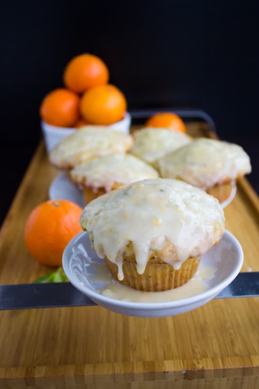 Ginger Clementine Lemon Poppy Seed Muffins. Easy one bowl one whisk muffins that BURST with lemon and poppy seed, spiked with a bit of ginger and clementine glaze. Don;t miss this RECIPE for the fluffiest, lightest, freshest tasting lemon poppy seed muffin ever! www.twopurplefigs.com