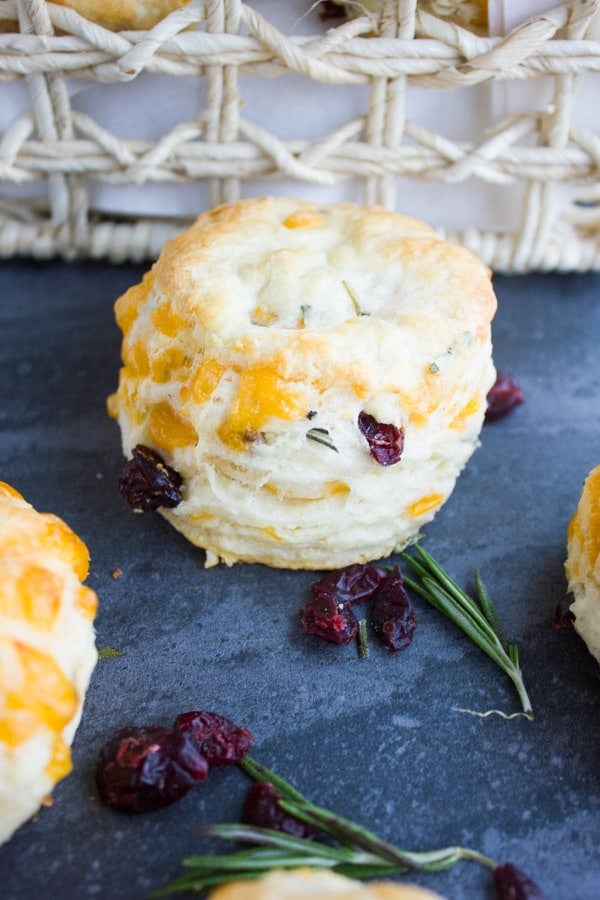 close-up of homemade buttermilk biscuit with cranberries, cheddar and rosemary