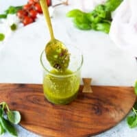 panzanella salad dressing in a bowl with a spoon showing the consistency.