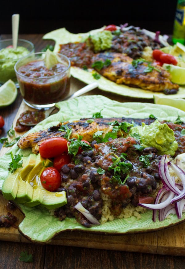 Mexican Style pan fried tilapia fillets served on a fish-shaped plate with Mexican side dishes