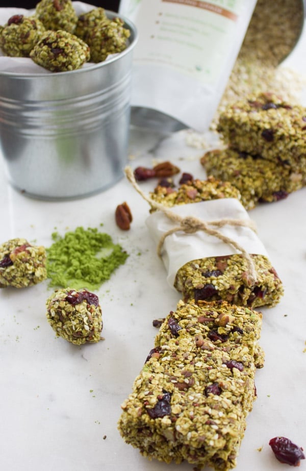 Banana Matcha Energy Bites and granola bites arranged on a white tabletop