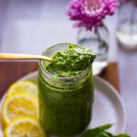 a spoonful of pistachio pesto over a jar of finished pistachio pesto