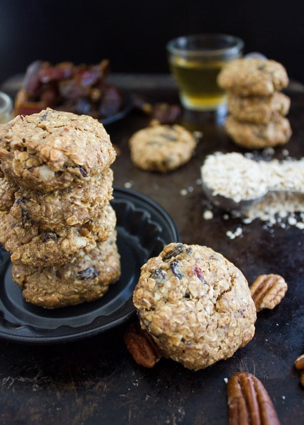a stack of gluten-free Vegan Oatmeal Raisin Cookies on a black table
