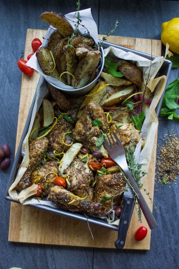 One Pan Chicken Potato Bake With Zaatar served on a tray with cutlery on the side 