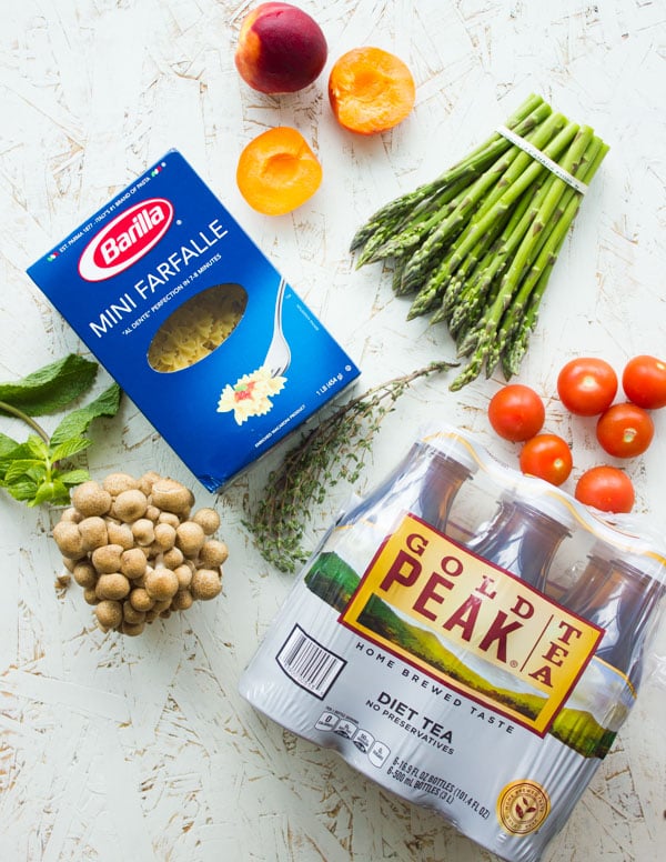 ingredients for summer pasta salad platter on a white tabletop.