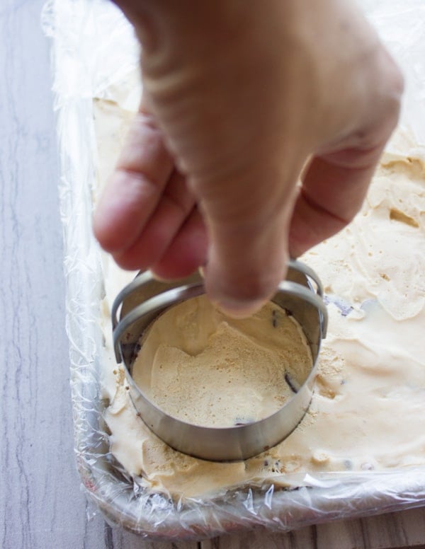 rounds being cut out of salted caramel ice cream with a cookie cutter