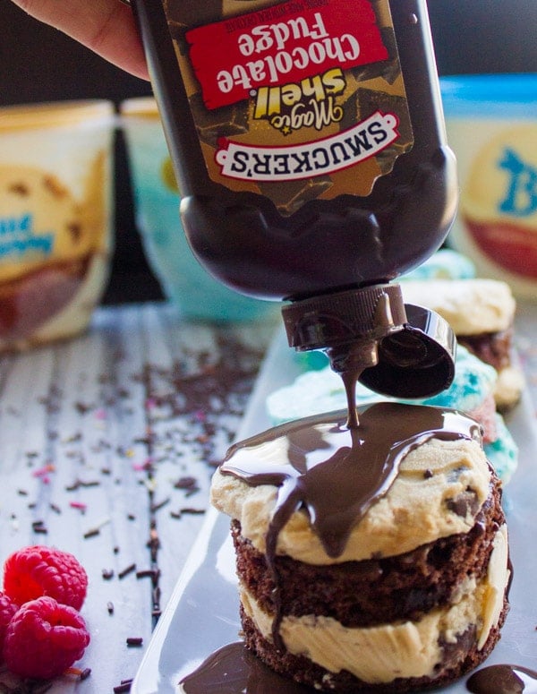 chocolate sauce being drizzled on top of a salted caramel mini ice cream cake