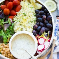 Lemon Cauliflower Rice Salad With Yogurt Dressing. Quick, easy and super delicious salad made with lemon cauliflower rice, plenty of veggies, fruits and goodies. A bright herb yogurt sauce drizzled on top to brighten the salad --a real crowd pleaser and a favorite for potluck! www.twopurplefigs.com