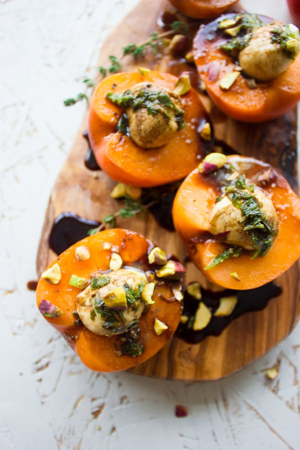 close-up of mozzarella stuffed apricots on a wooden board