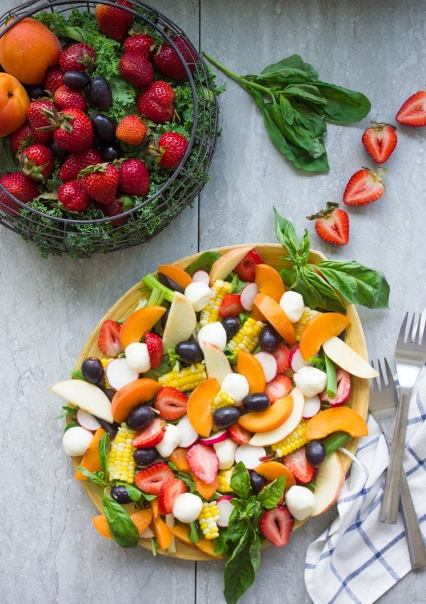 Summer Salad With Fruits & Basil. Swap your veggies, heavy dressings and bring on fruits, corn and some kale for a fresh BBQ salad favorite! Drizzled with a cream Basil Avocado Vegan dressing that you will use on anything and everything--not just the salad! Make this recipe today-www.twopurplefigs.com