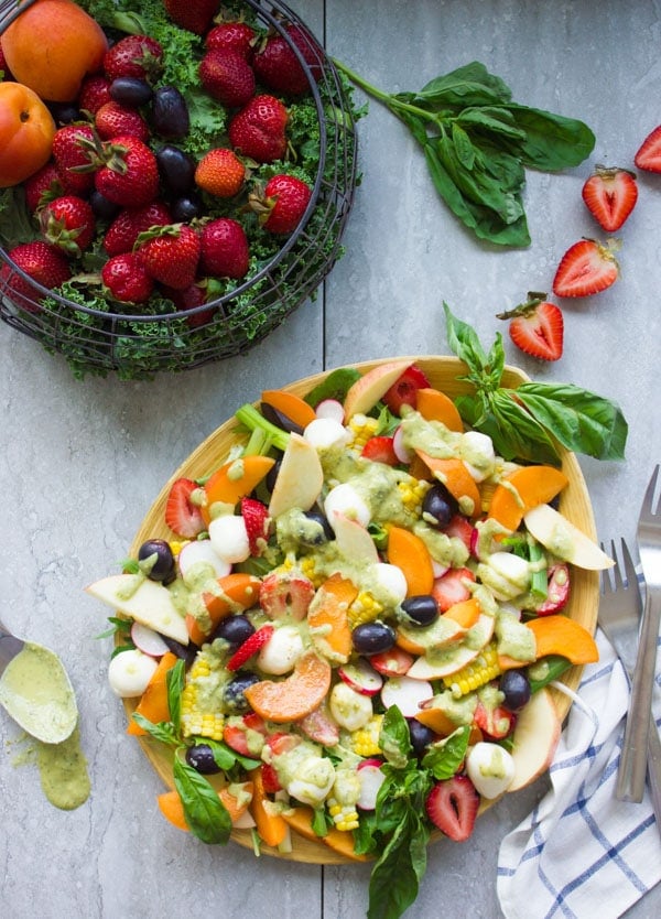 Summer Salad With Fruits & Basil. Swap your veggies, heavy dressings and bring on fruits, corn and some kale for a fresh BBQ salad favorite! Drizzled with a cream Basil Avocado Vegan dressing that you will use on anything and everything--not just the salad! Make this recipe today-www.twopurplefigs.com