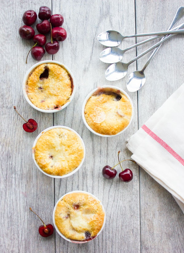 overhead shot of four individual ramekins with Sweet Cherry Buckle