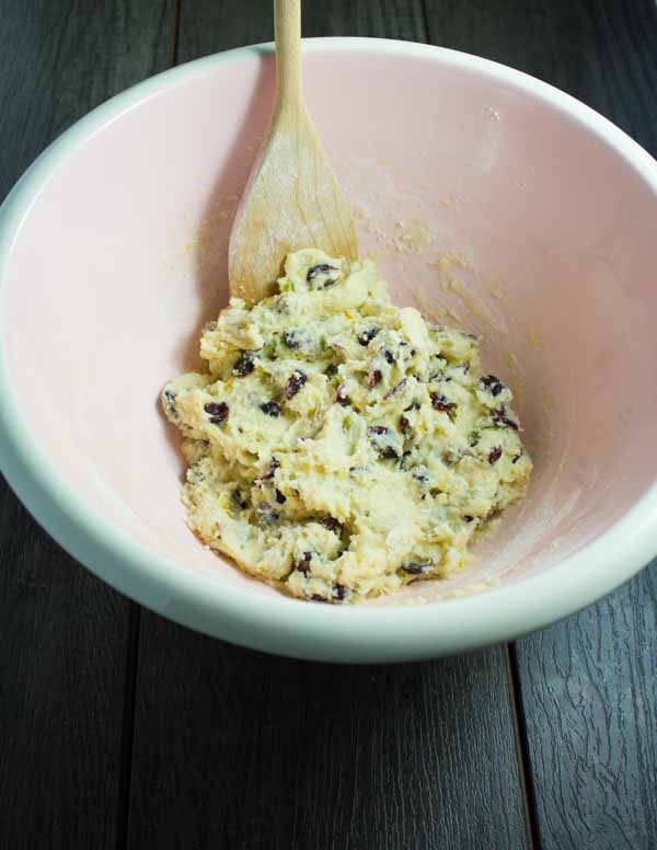 Cranberry Pistachio Biscotti dough being mixed in a pink bowl