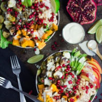 Lentil Fall Harvest Buddha Bowl. This easy, crazy delicious Buddha goodness bowl is all you need to make your life happier! Loaded with greens, lentils, navy beans, apples, avocado, sweet potatoes, sprouts, pomegranate arils--all drizzled with the perfect tahini sauce! Get this recipe and tips for Buddha bowl perfection. www.twopurplefigs.com