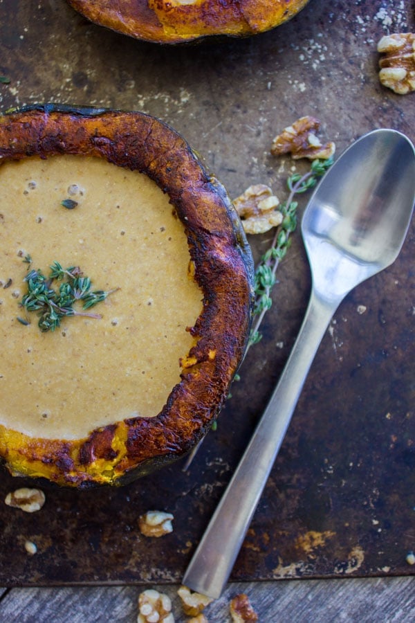 partial view of a roasted kabocha squash cup filled with vegan squash soup