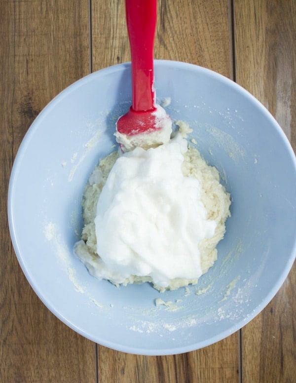 egg whites being folded into the vanilla cake batter