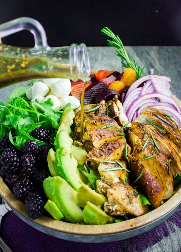 side view of a bowl of Chicken Salad with balsamic marinated chicen breast, blackberries and avocados