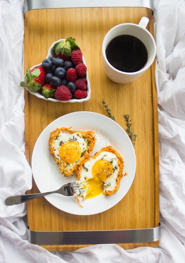 Baked Eggs in Sweet Potato Crust served on a breakfast tray with perfectly cooked yolks