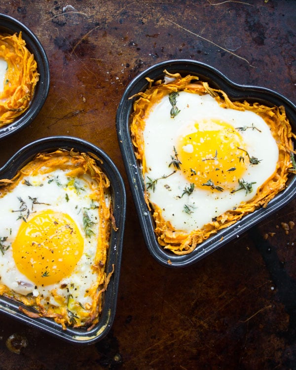 Eggs cracked into heart-shaped sweet potato crust before baking