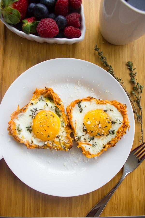 Overhead shot of Baked Eggs in Sweet Potato Crusts with salt and herbs sprinkled on top