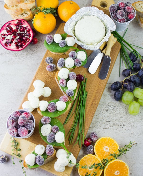 Frosted Cranberries served on cheese crostini with little cream cheese balls