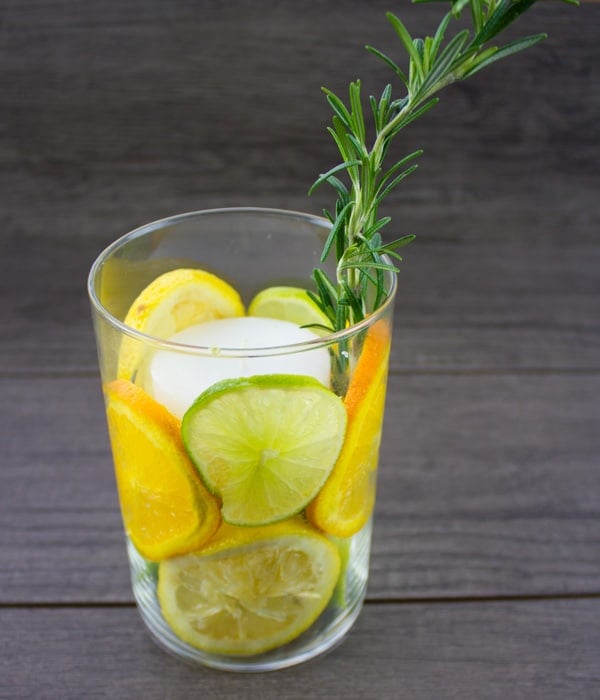 citrus fruit candle holder with a sprig of rosemary