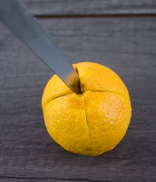 a tangerine being turned into a candle