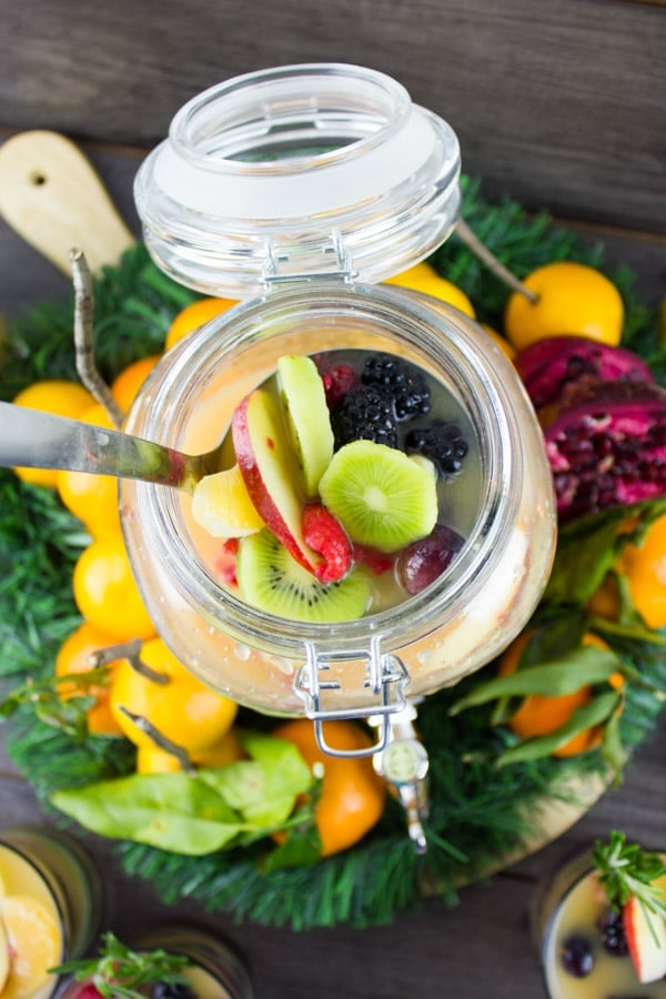 a jar of Fruity Non-Alcoholic Sangria being stirred with a spoon