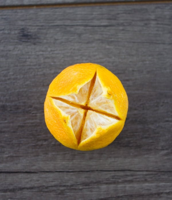 a tangerine being turned into a candle