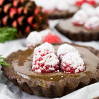 side view of Mini Raspberry Chocolate Tart topped with fresh raspberries