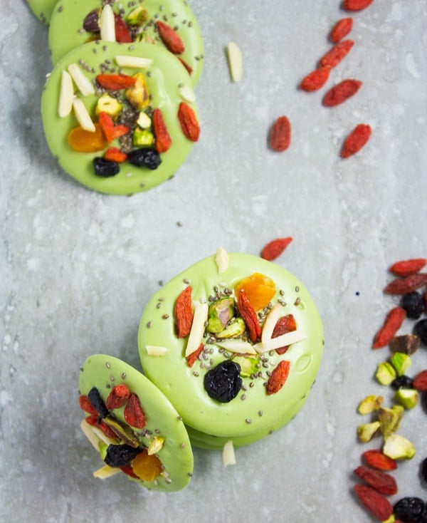 overhead shot of Matcha White Chocolate Bark rounds on a marble countertop