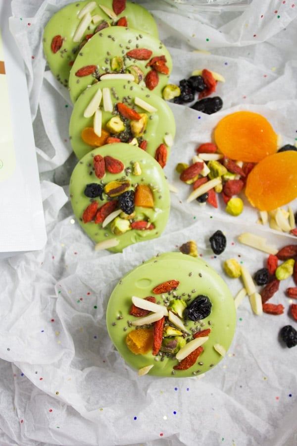 rounds of Matcha Green Tea White Chocolate Bark lined up on white parchment paper