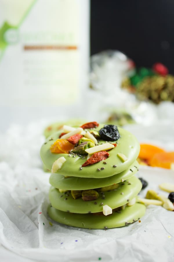 side view of stacked round Matcha White Chocolate Bark topped with dried fruits