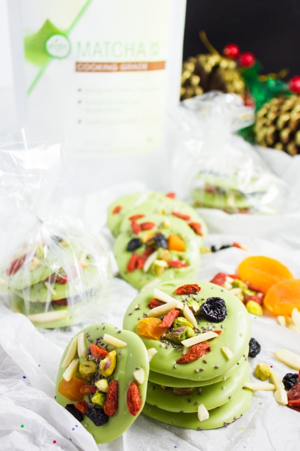 Superfood Matcha Green Tea Chocolate Bark rounds - some stacked, some wrapped as a present