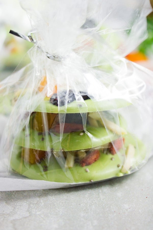  side view of a stack of Matcha Green Tea Chocolate Bark wrapped in transparent giftwrapper