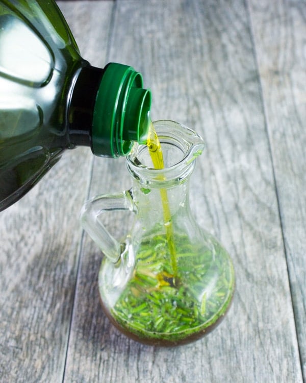 oil bring added to the Coca-Cola Dressing in a glass decanter