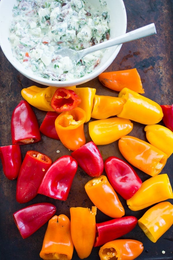 little mini bell peppers next to a bowl with feta filling