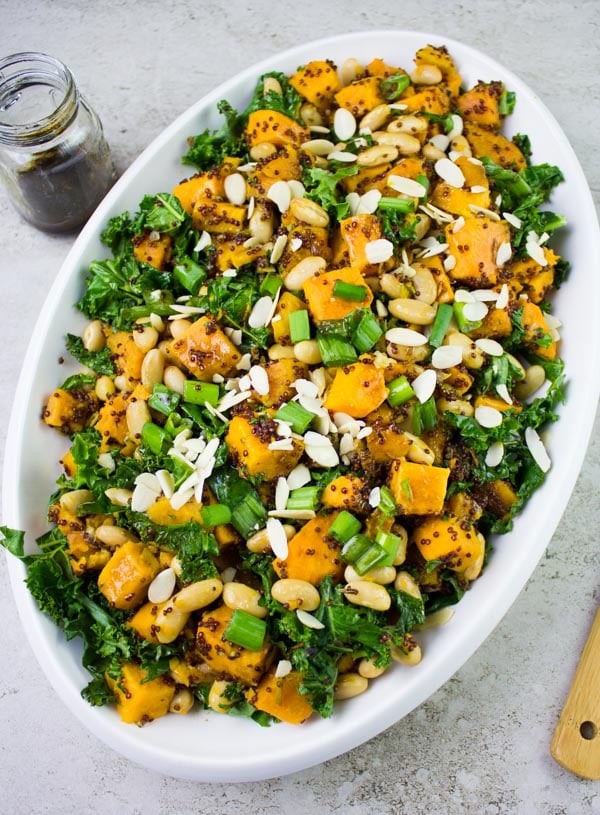 One Pot Quinoa Sweet Potato Salad served in an oval salad bowl sprinkled with slivered almonds and chopped scallions