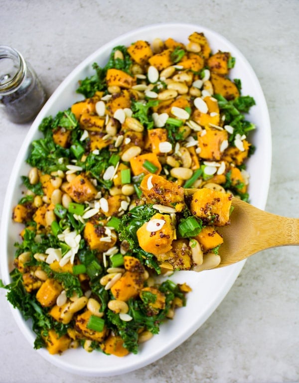 One Pot Quinoa Sweet Potato Salad served in an oval salad bowl sprinkled with slivered almonds and chopped scallions